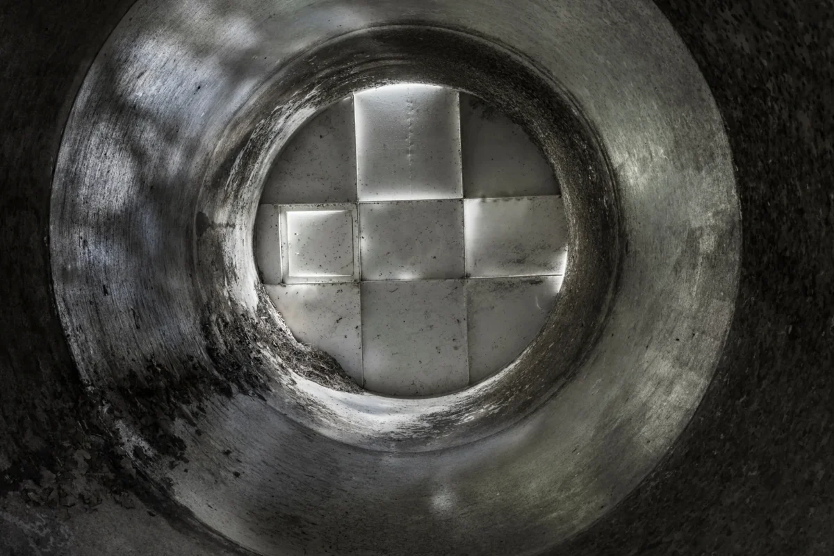 View of the internal walls and roof structure of an empty grain silo.